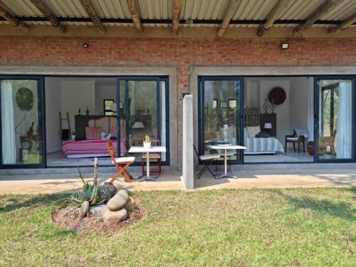 a extension of a house with windows and a patio at Crocodile Sands River Lodge in Nelspruit