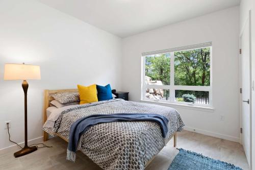 a bedroom with a bed and a window at Surf Park Place in Garden City
