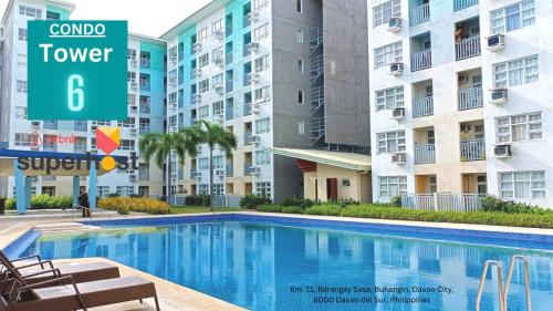 a swimming pool in a apartment complex with buildings at Seawind Condo - Sea View Samal Island View Gene Vacation Homes in Davao City