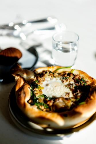 a small pizza on a plate on a table at Shark B&B in Hengchun
