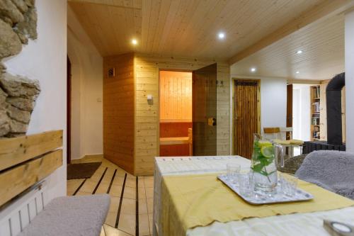 a room with a table and chairs and a bathroom at Chalupa v Meziluzi in Meziluží