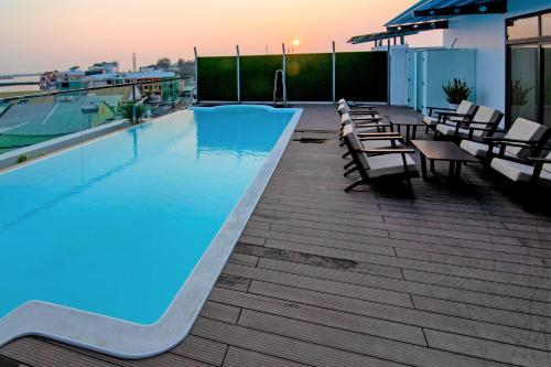 a swimming pool on the roof of a building at VISUHA HOTEL in Hà Tiên