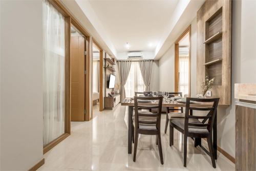 a dining room with a table and chairs at Grande Valore Hotel Cikarang in Cikarang