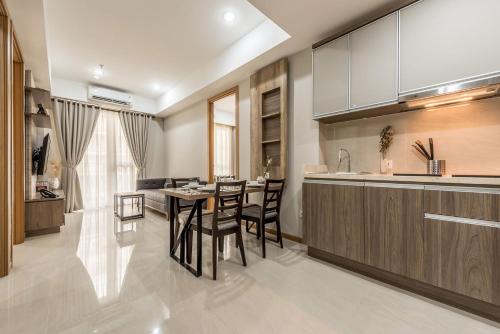 a kitchen and dining room with a table and chairs at Grande Valore Hotel Cikarang in Cikarang