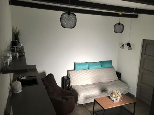 a bedroom with a bed with blue pillows and a table at Sigulda City Center Holiday House in Sigulda