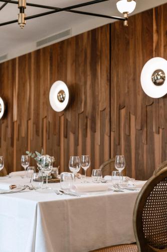 a dining room with a table with wine glasses at Palacio de Aviles Affiliated By Melia in Avilés
