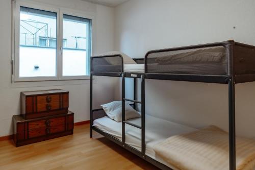 a room with two bunk beds and a window at -City-Apartment, Buchs SG, Skie, Wanderroute, WiFi- in Buchs
