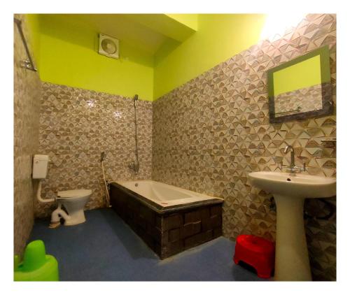 a bathroom with a sink and a tub and a toilet at Green Vista Resort in Chālsa