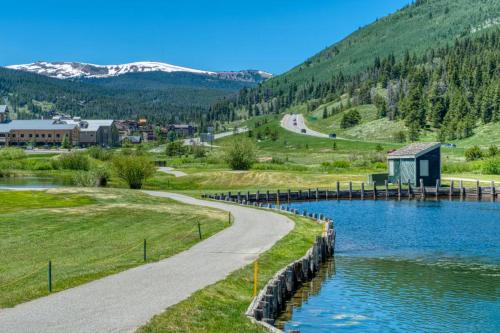 a road next to a body of water with a building at Ten Mile Haus in Frisco