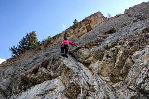 a person is climbing up a rocky mountain at Ten Mile Haus in Frisco