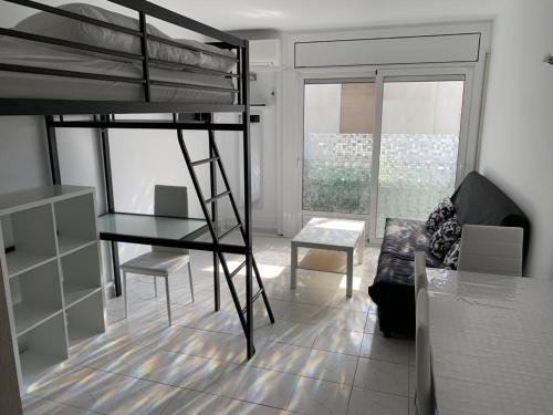 a bedroom with a bunk bed and a living room at Agi Estrella de Mar in Roses
