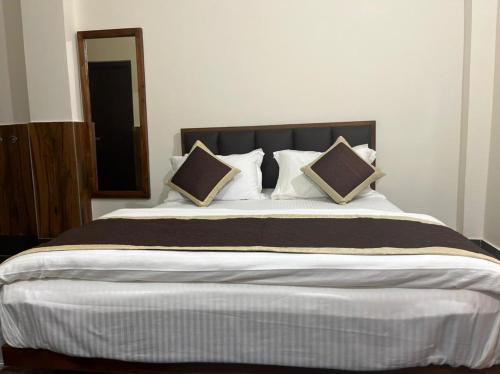 a bedroom with a large bed with pillows at Dzomo Homestay in Gangtok
