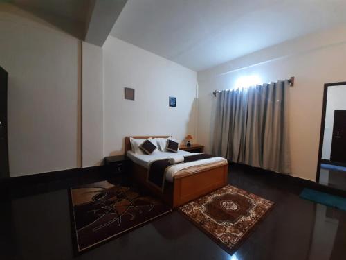 a living room with a bed and a window at Dzomo Homestay in Gangtok