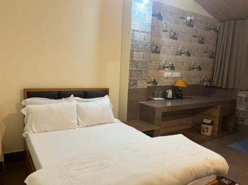 sypialnia z łóżkiem i biurkiem w obiekcie Dzomo Homestay w mieście Gangtok