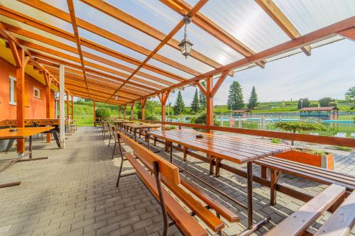 a row of wooden benches in a pavilion at Penzion Bolatice in Bolatice