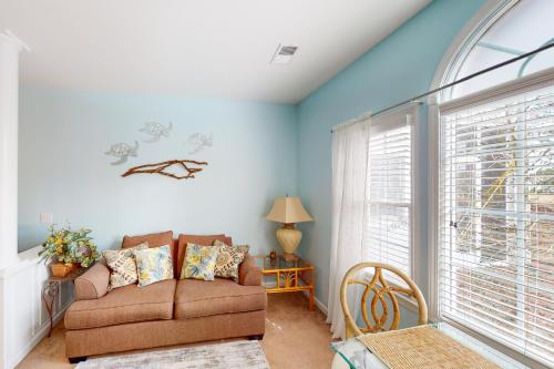 a living room with a couch and a window at Away on Avian - Unit #3406b in Sunset Beach