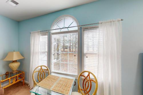 a dining room with a table and a window at Away on Avian - Unit #3406b in Sunset Beach