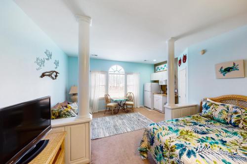 a bedroom with a bed and a living room at Away on Avian - Unit #3406b in Sunset Beach