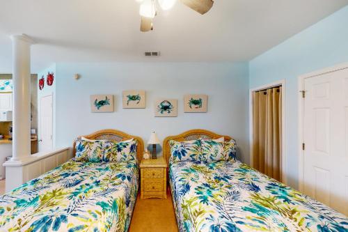 two beds sitting next to each other in a bedroom at Away on Avian - Unit #3406b in Sunset Beach