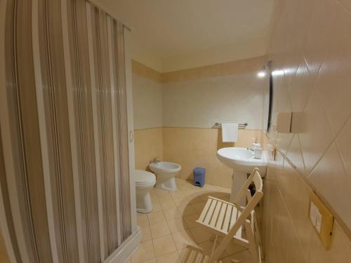a bathroom with a shower and a toilet and a sink at B&B Liberty in Palermo