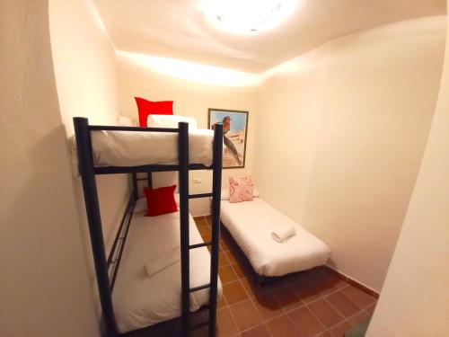 a small room with two bunk beds in it at Plaza Andalucía Edificio Salvia in Monachil