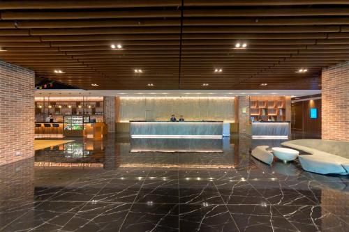 a lobby with a bar in the middle of a building at JANDA Golden Tulip Hotel in Wuqi