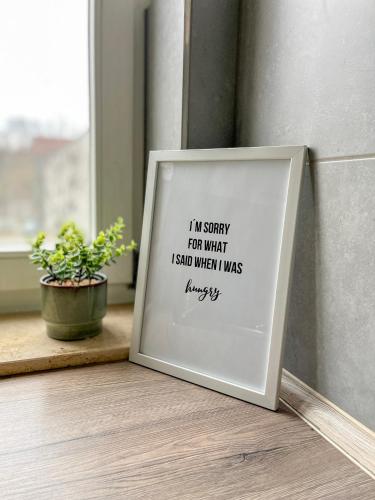 a picture frame sitting on a floor next to a window at Schöne moderne Wohnung Smart Tv in Waldstetten