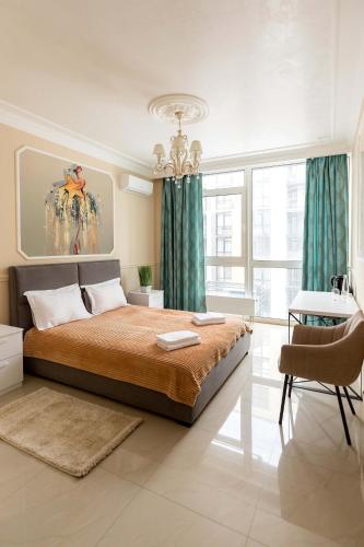 a bedroom with a large bed with green curtains at Sun apartments in Kyiv