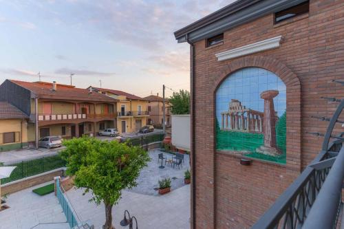 a mural on the side of a brick building at Villa Vimani in Paestum