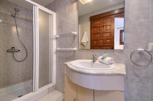 a bathroom with a sink and a shower at Casa Virginia in Jávea