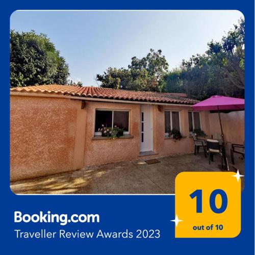 a picture of a small house with a sign that says travel review awards at Indè Noi - Maison de village proche commodités in Murato