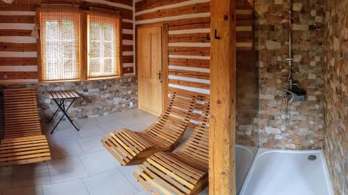 a room with two chairs and a bath tub at Wellness chata - Krkonoše in Rudník