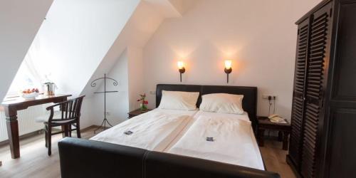 1 dormitorio con cama, escritorio y silla en Hotel zur Römerbrücke en Neuwied