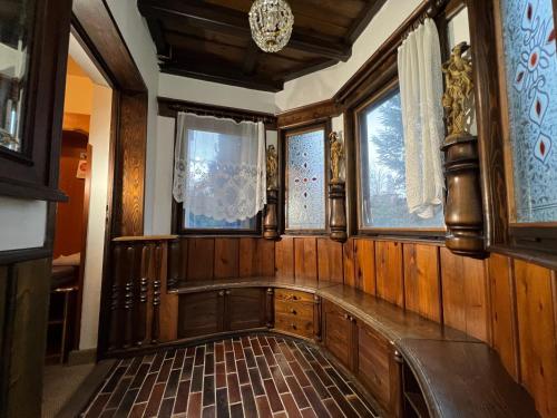 an empty room with wooden walls and windows at Schlosshotel Marienbad in Mariánské Lázně