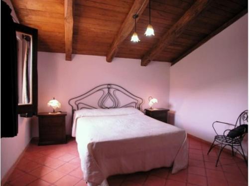 een slaapkamer met een wit bed en 2 nachtkastjes bij Casa Gruppetta in Tortorella