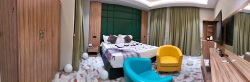 um quarto de hotel com uma cama e duas cadeiras em Karbala blazma em Karbala