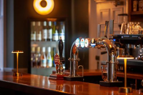 a bar with a counter top with a bar at The Dower House Hotel in Woodhall Spa