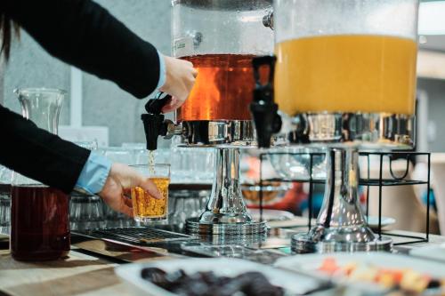 two people making drinks on a bar at Hotel De Normandie in Saint Helier Jersey