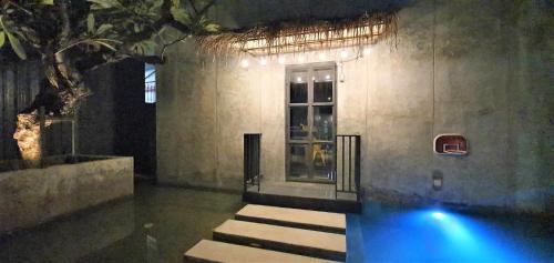 a room with a swimming pool in a building at Villa by the Win Pattaya in Jomtien Beach