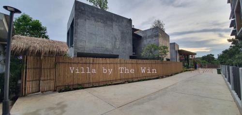 a building with a fence with the words villa by the win at Villa by the Win Pattaya in Jomtien Beach