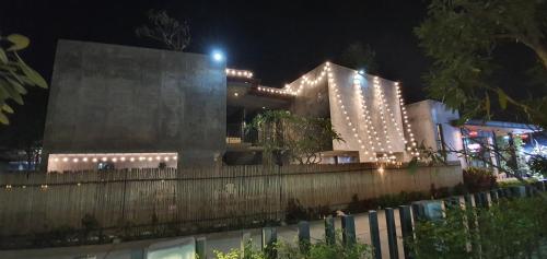 a building with lights on it at night at Villa by the Win Pattaya in Jomtien Beach