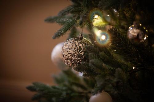 a christmas tree with a ball ornament on it at The Dower House Hotel in Woodhall Spa