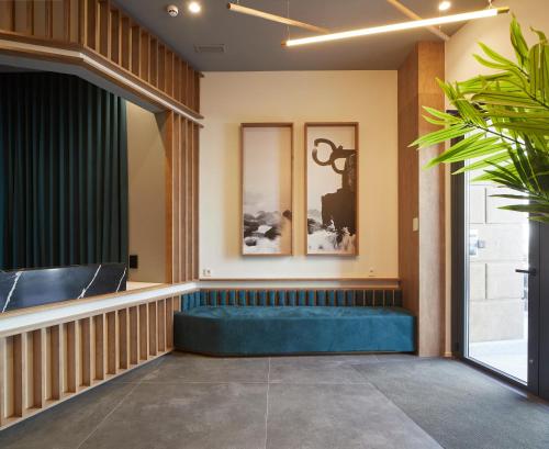 a waiting area with a blue couch in a building at Gran Zubieta La Concha in San Sebastián