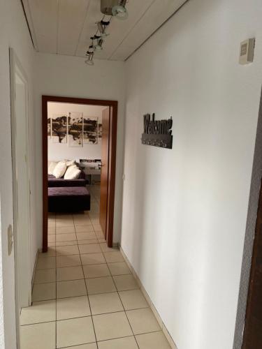 a hallway with a bed and a sign on a wall at Gemütliche Ferienwohnung auf dem Land in Bockenau