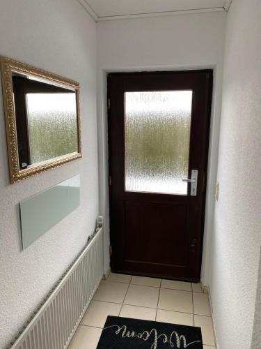 a black door in a room with a tile floor at Gemütliche Ferienwohnung auf dem Land in Bockenau