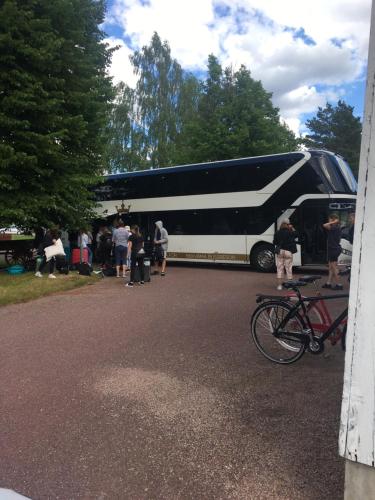 a group of people standing outside of a bus at Trunna Vandrarhem & Konferens in Orsa