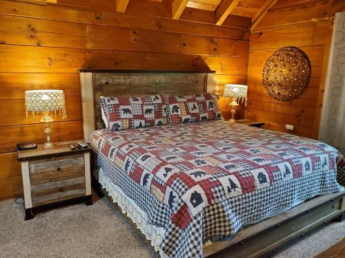 a bedroom with a bed and a wooden wall at Foxy Lady #1531 in Gatlinburg