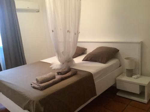 a bedroom with a bed with two towels on it at VILLA ALIZEE APPARTEMENT N°6 in Sainte-Rose
