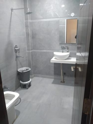 uma casa de banho com um lavatório, um WC e um espelho. em Hotel Uday Raj By WB Inn em Agra