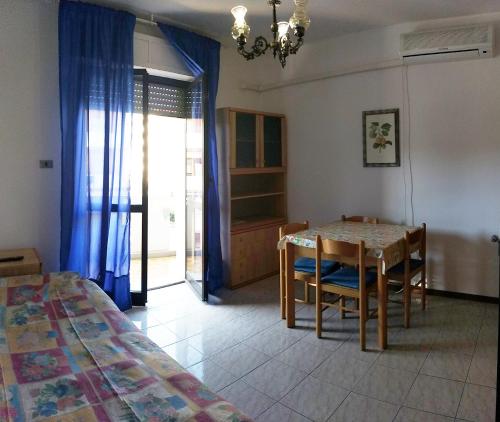 a room with a table and chairs and a bedroom at Appartamenti Primula Uno in Silvi Marina